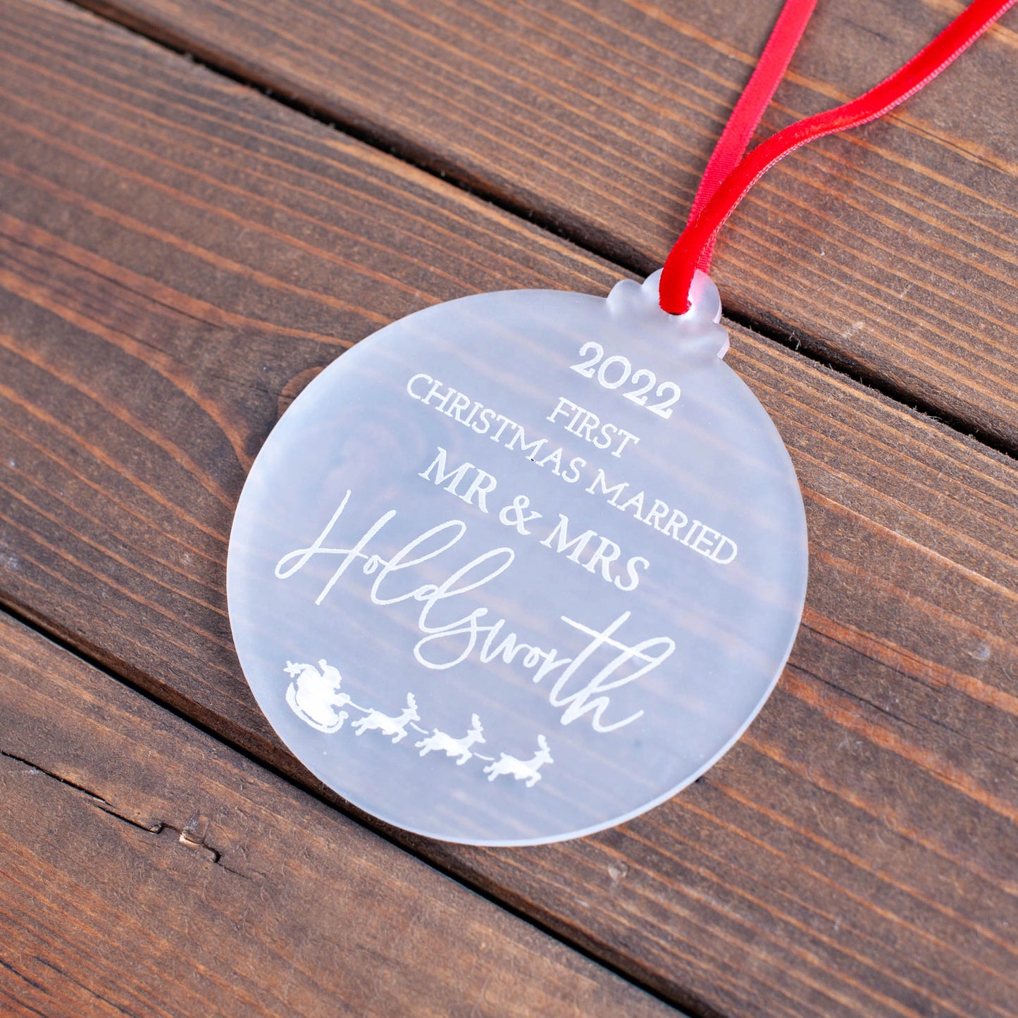 Elegant first Christmas married ornament hanging on tree