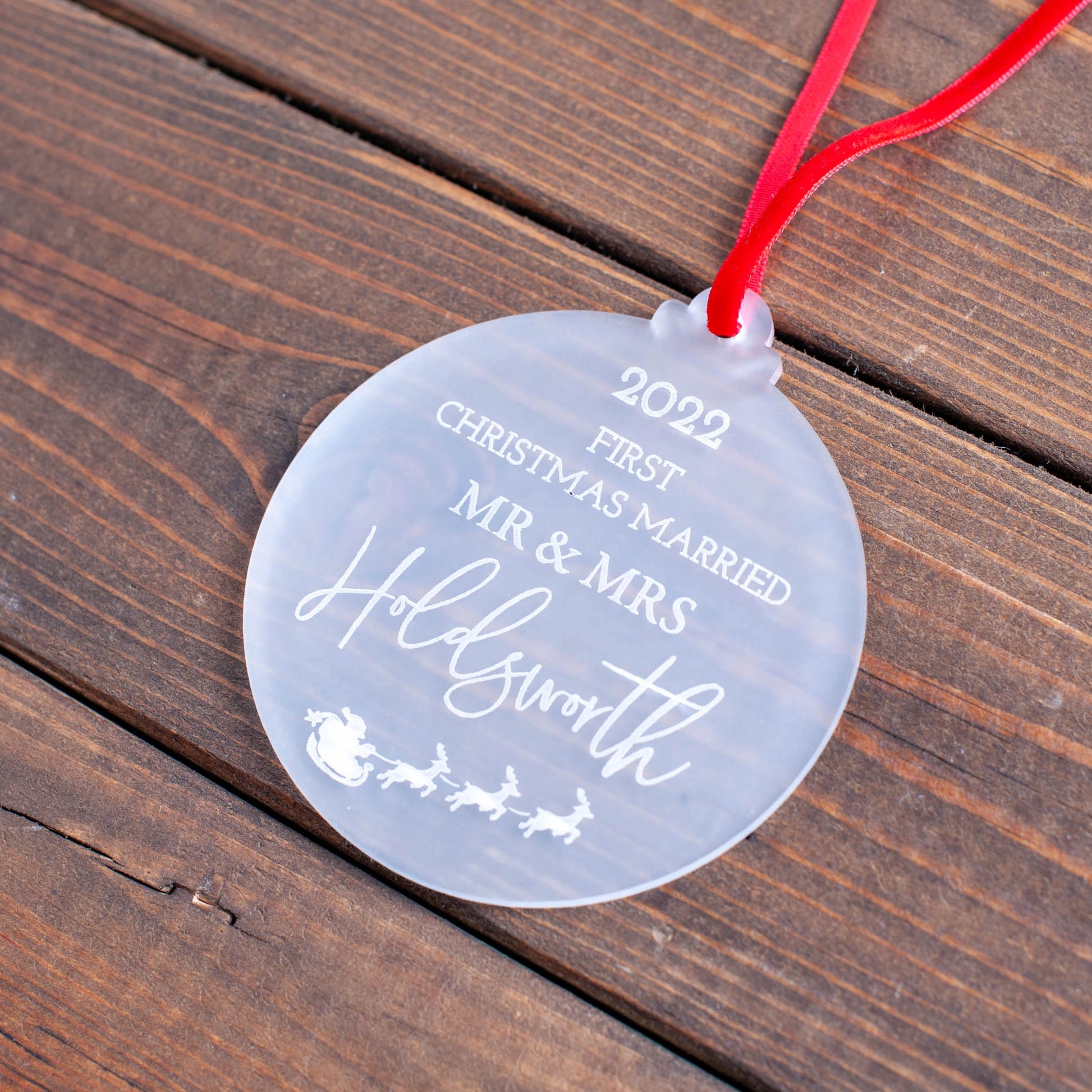 Elegant first Christmas married ornament hanging on tree
