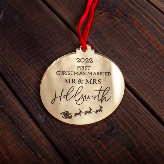 Elegant reflective gold ornament celebrating couple’s first Christmas married