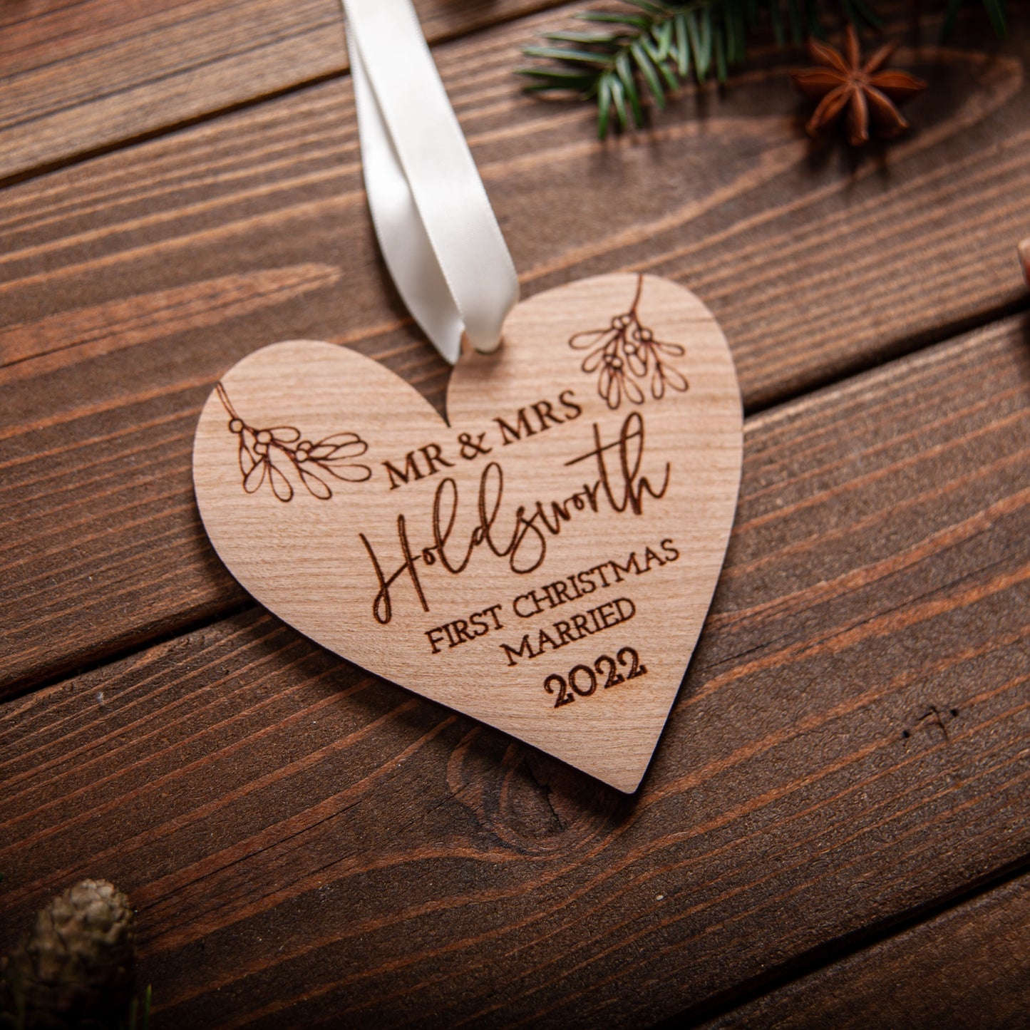 Wooden heart ornament engraved with couple’s names and year