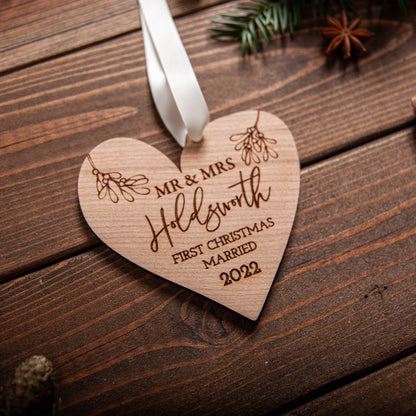 Wooden heart ornament engraved with couple’s names and year
