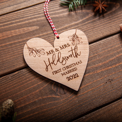 Custom heart-shaped ornament personalised for newlyweds with ribbon