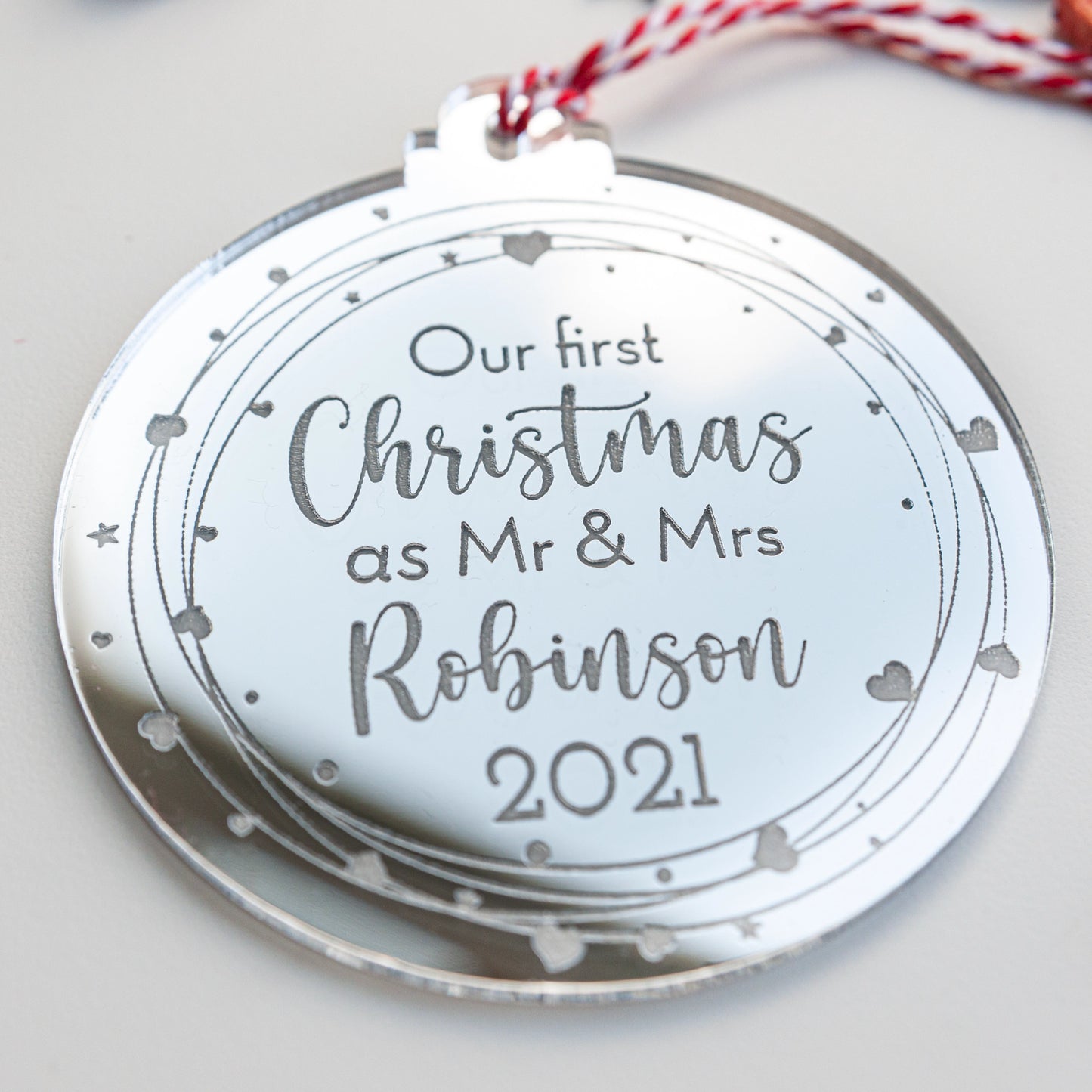 Reflective silver acrylic ornament engraved with couple’s names and year