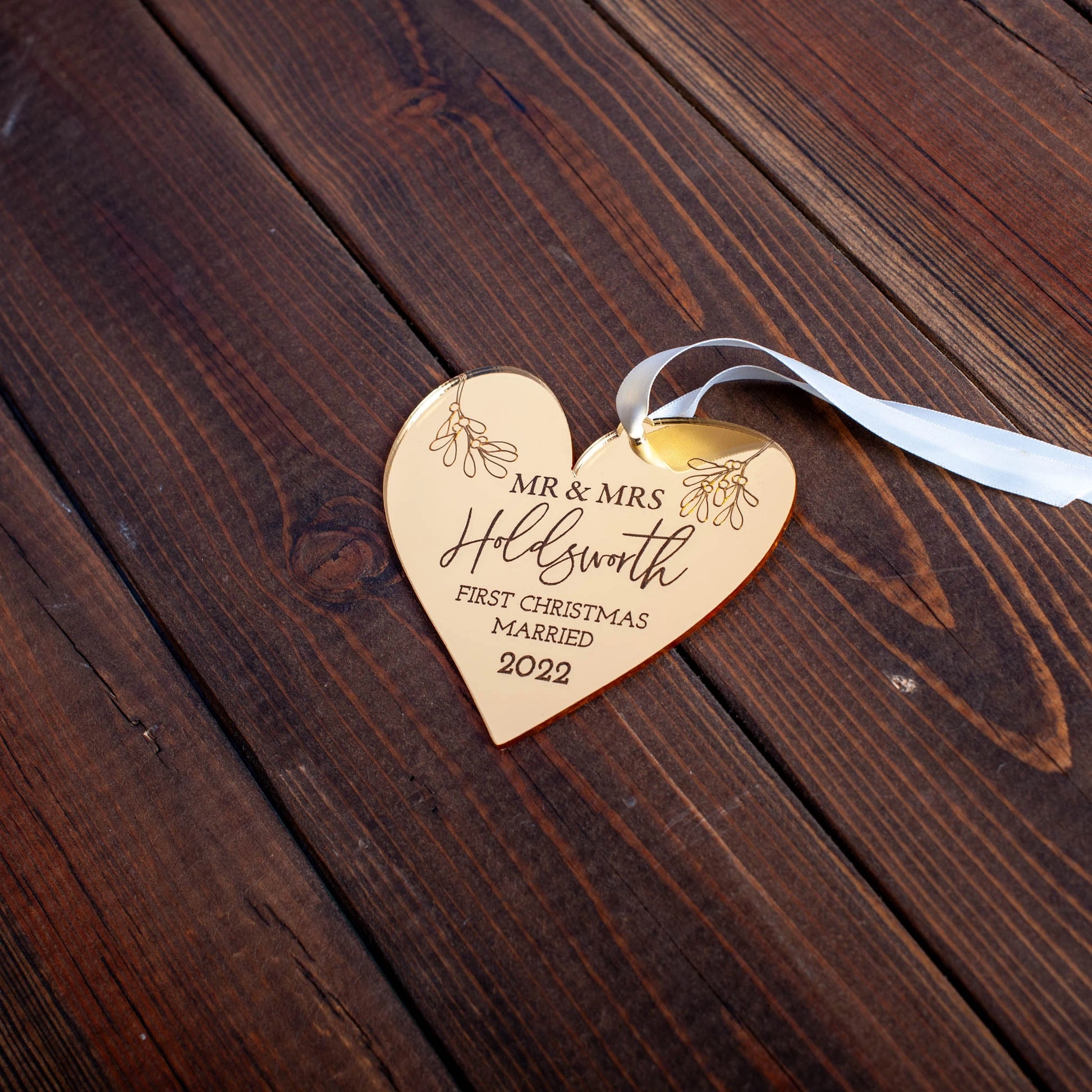 Engraved gold mirror ornament celebrating first Christmas married