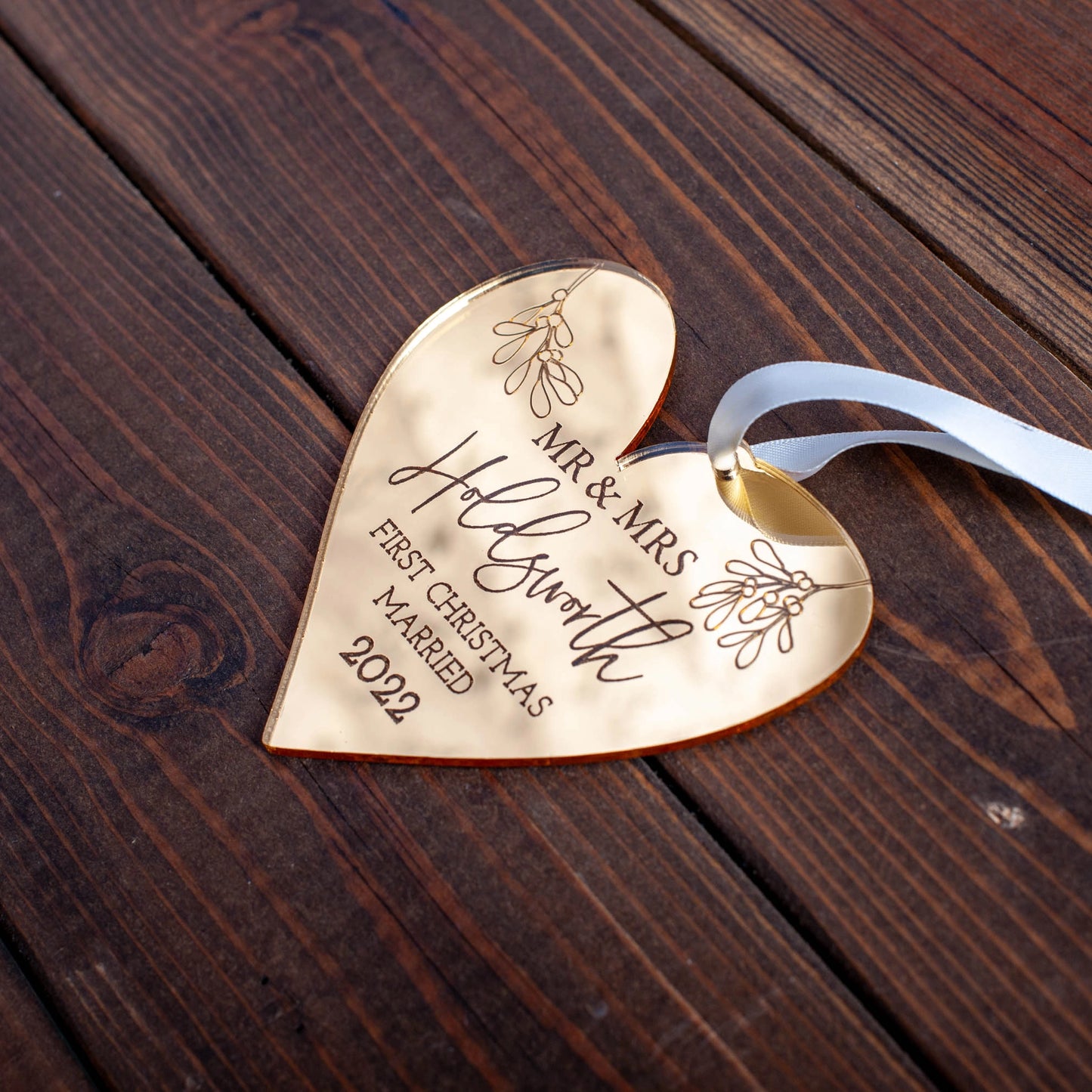 Custom heart-shaped gold acrylic bauble engraved with names and year