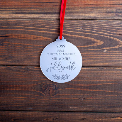 Mirror acrylic bauble engraved with “Our First Christmas Married”