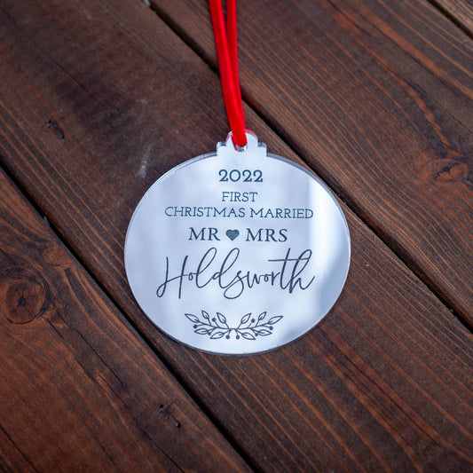 Gold mirror bauble engraved with couple’s names and first Christmas message