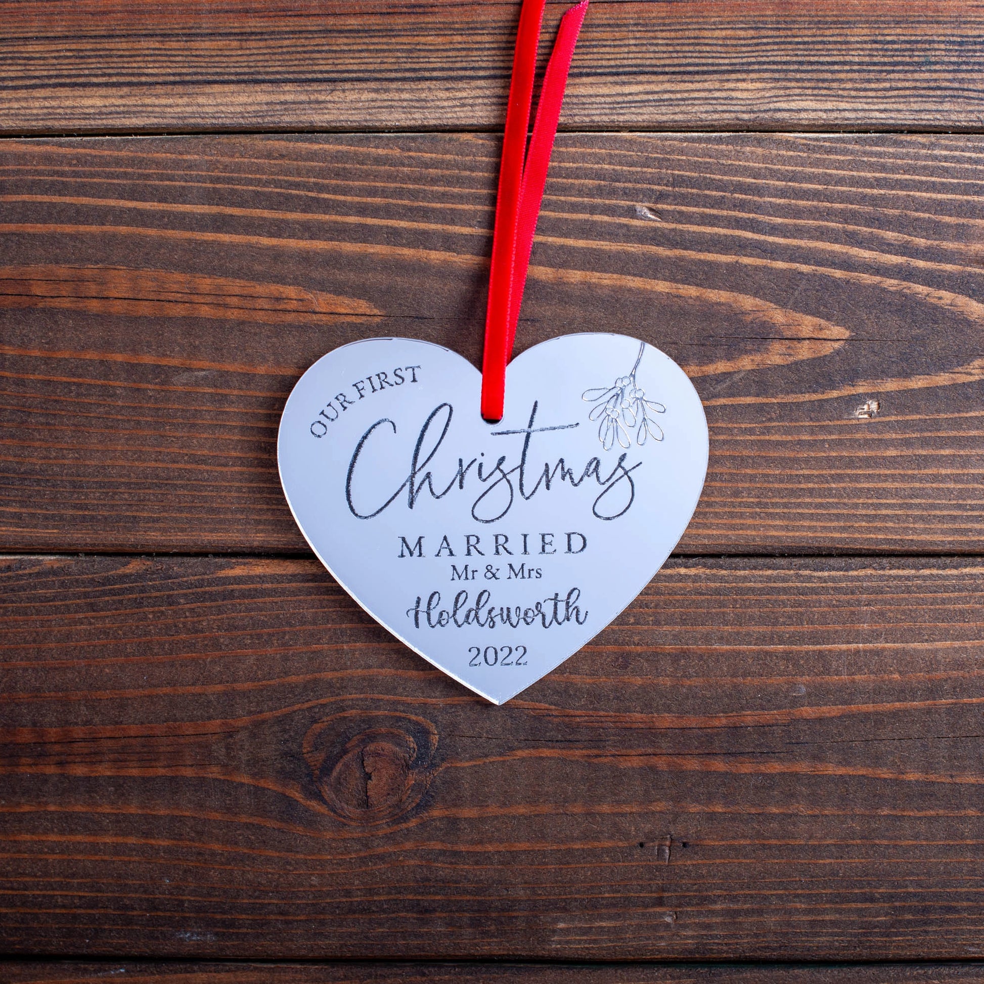 Elegant reflective mirror bauble celebrating first Christmas as newlyweds