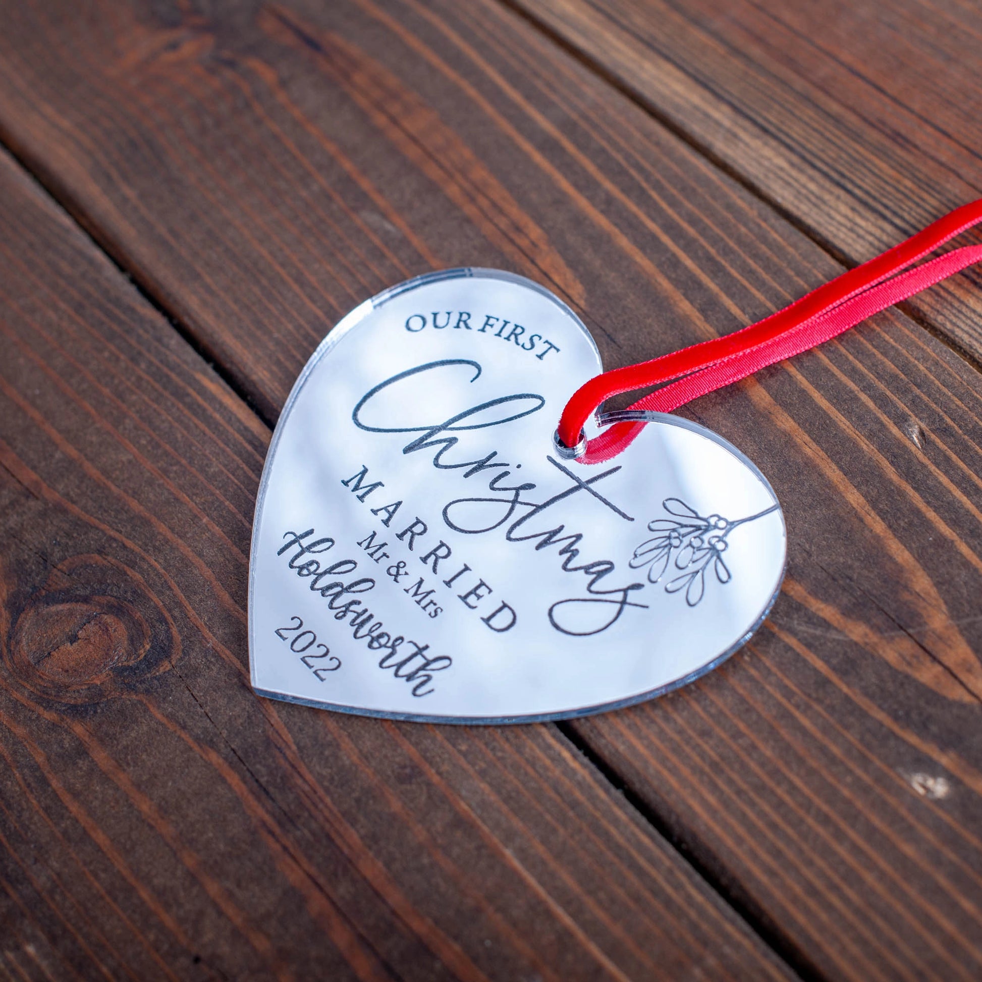 Engraved mirror acrylic heart bauble with Our First Christmas text