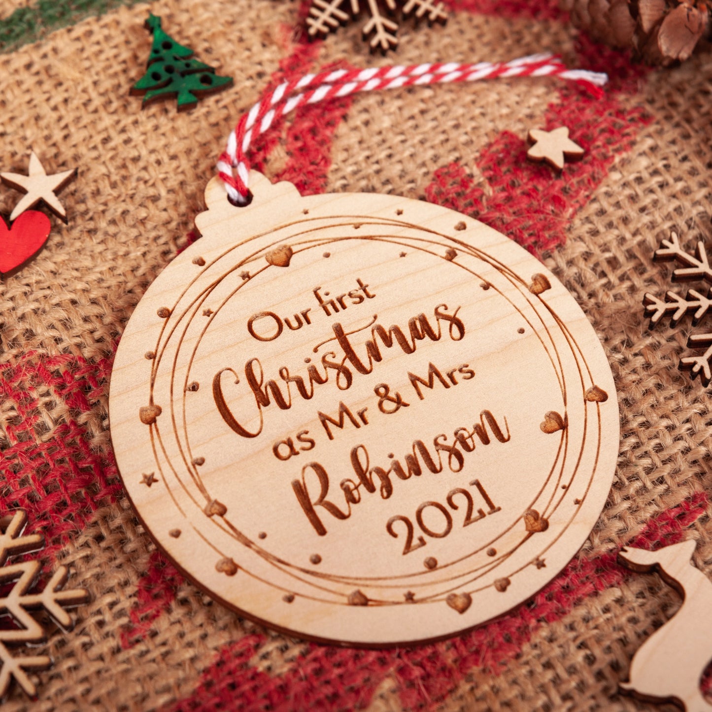 Engraved Mr & Mrs wooden ornament hanging on Christmas tree