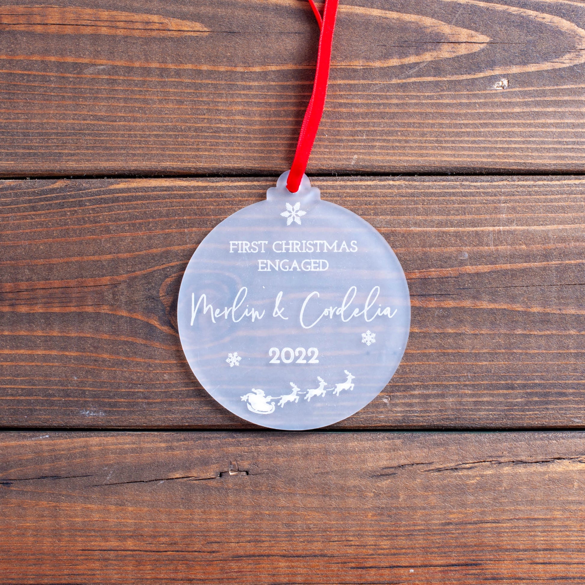 Laser engraved frosted bauble with couple’s names and year