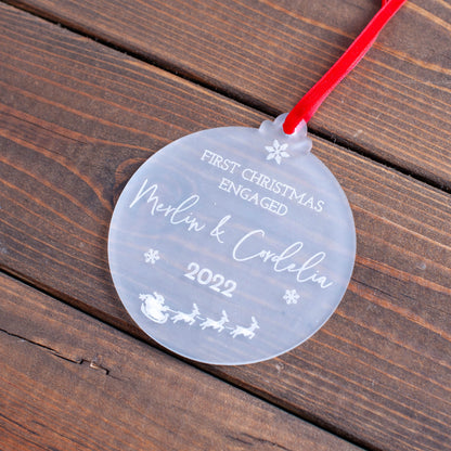 Elegant first Christmas engaged ornament hanging on festive tree