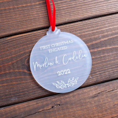 Frosted acrylic ornament engraved with couple’s names and engagement year