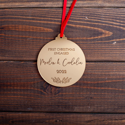 Personalised gold ornament engraved with engagement year and names