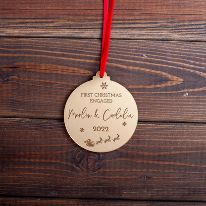 Engraved gold acrylic ornament celebrating engagement