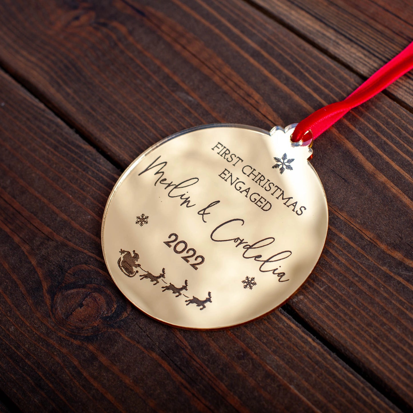 Personalised gold mirror engagement bauble hanging on Christmas tree