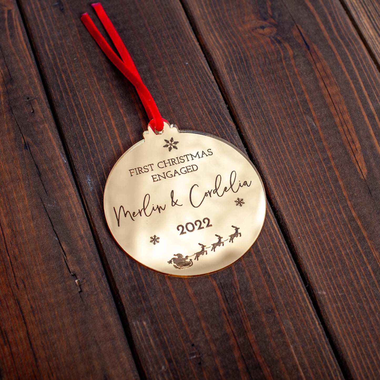 Engraved First Christmas engaged ornament in gold mirror finish