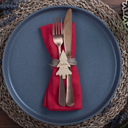 Stylish personalised Christmas tree place card with engraved guest name at luxury winter wedding table