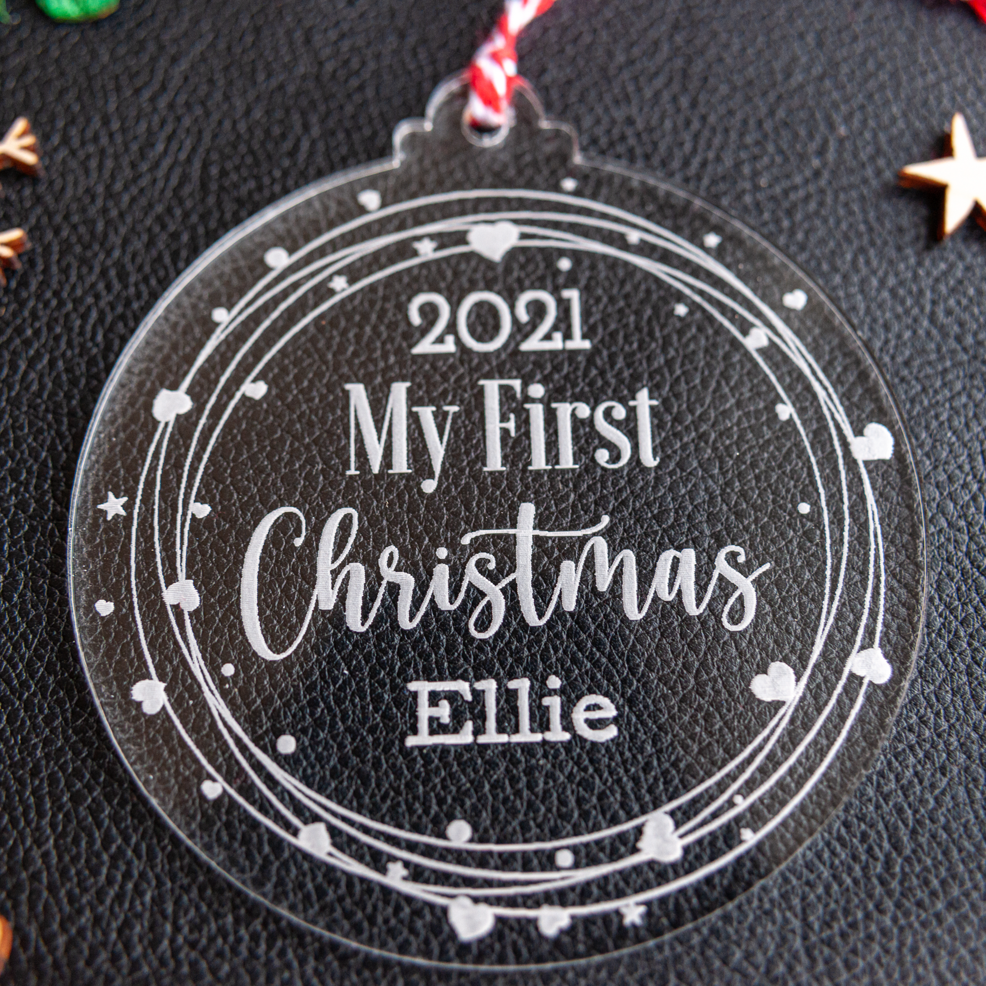 Acrylic first Christmas bauble with heart wreath design and ribbon