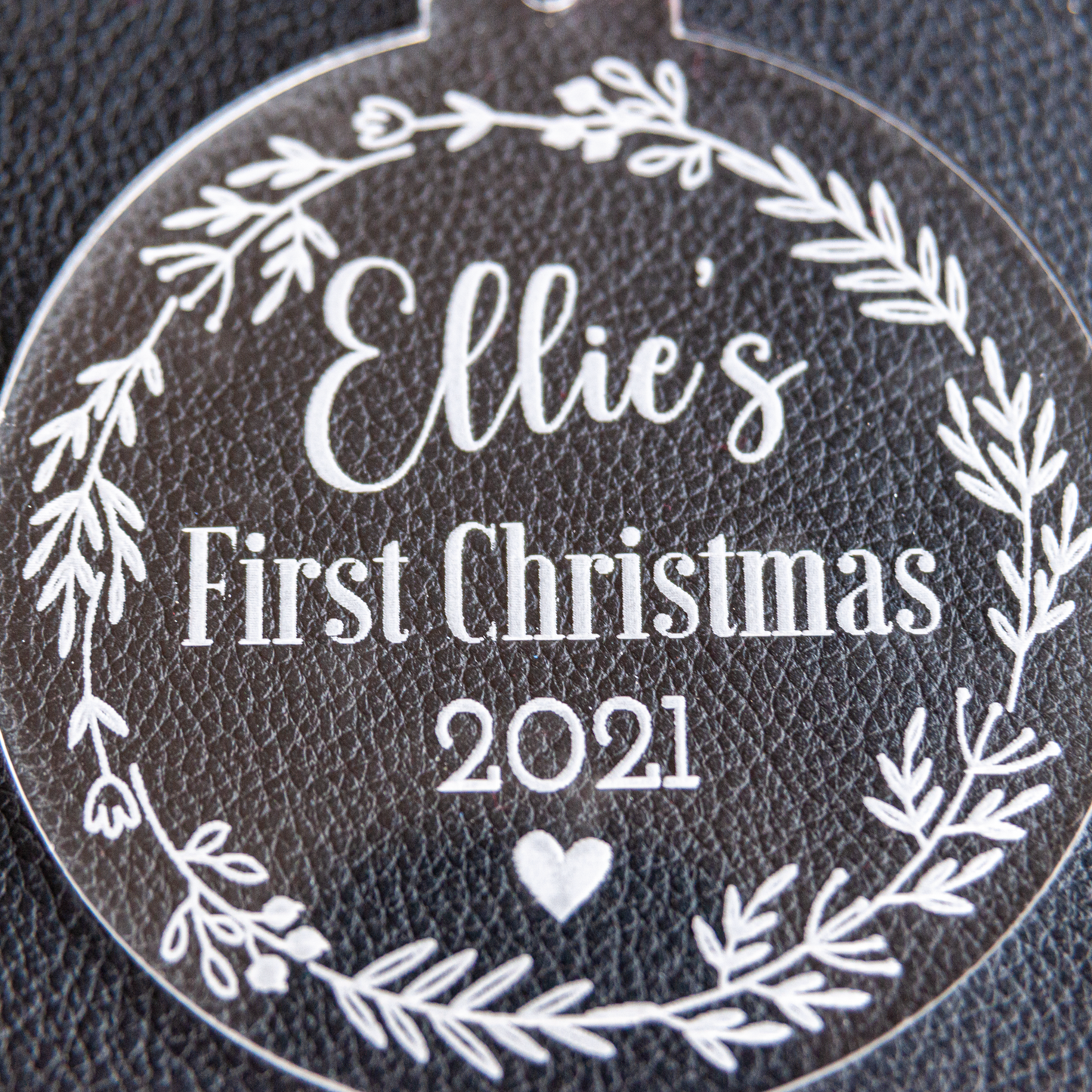 Close-up of engraved flower wreath baby keepsake bauble