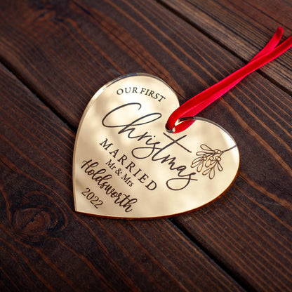 Engraved gold acrylic heart decoration celebrating first Christmas
