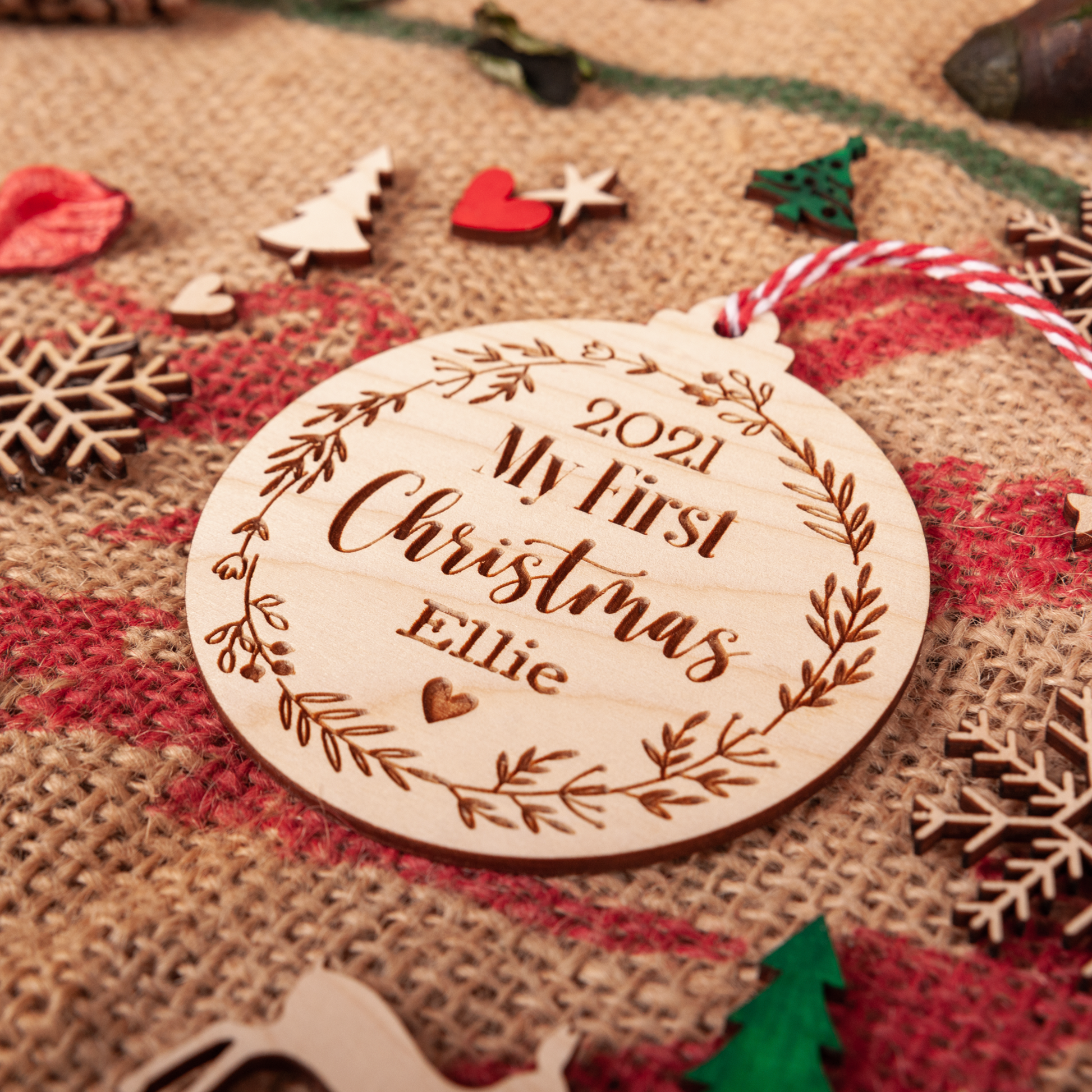 Wooden baby’s first Christmas ornament hanging on tree