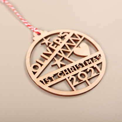 Wooden cut-out name bauble personalised for baby’s first Christmas