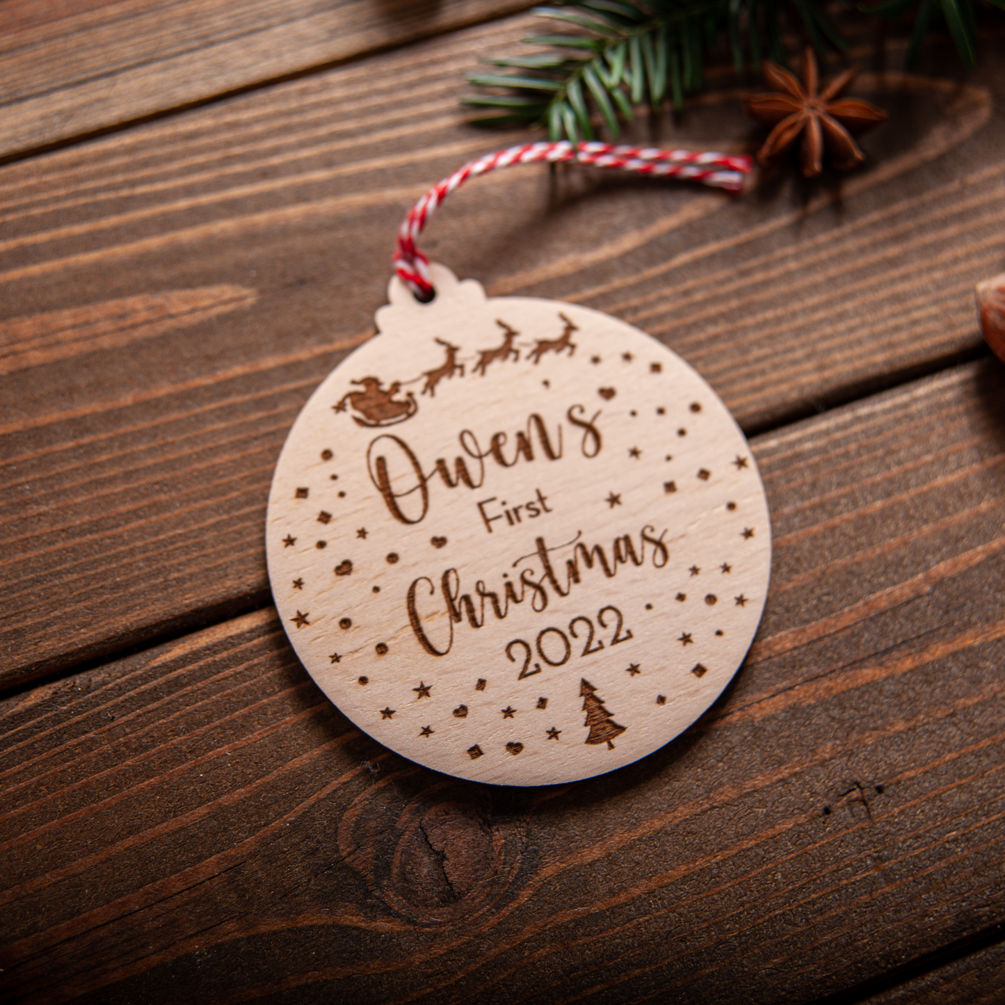 wood snow-globe inspired ornament personalised for baby’s first Christmas