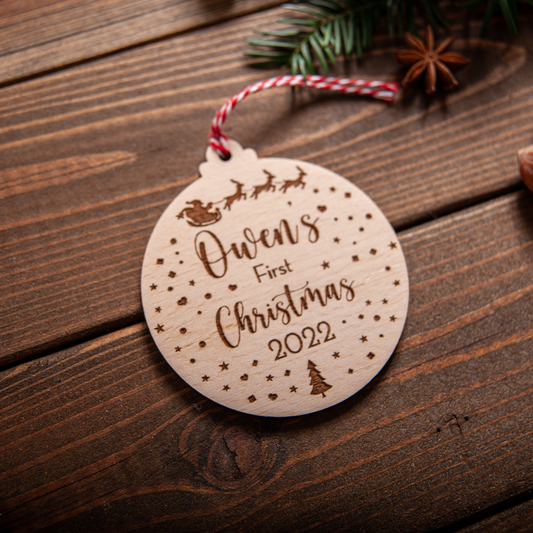 wood snow-globe inspired ornament personalised for baby’s first Christmas