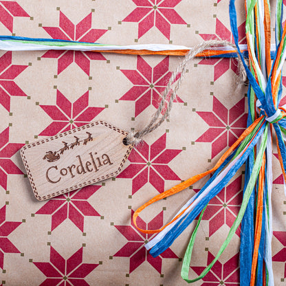 Personalised Santa and sleigh wooden ornament used as gift tag