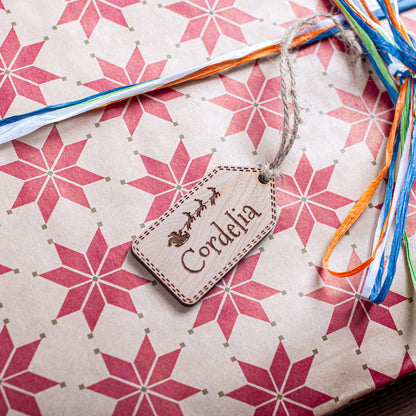 Rustic wooden gift tag engraved with Santa sleigh detail for Christmas presents