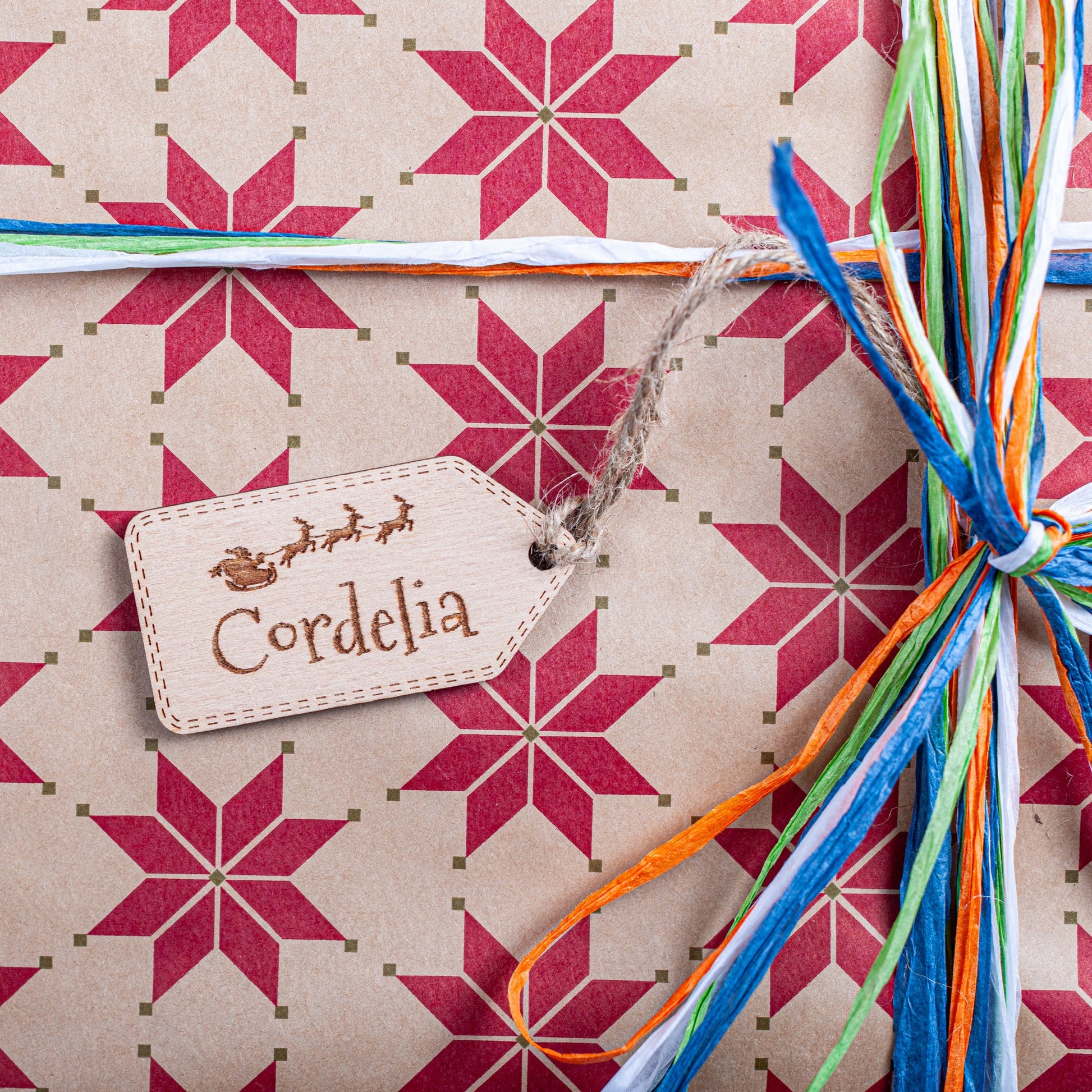 Wooden personalised Christmas gift tag with Santa sleigh engraving and jute string