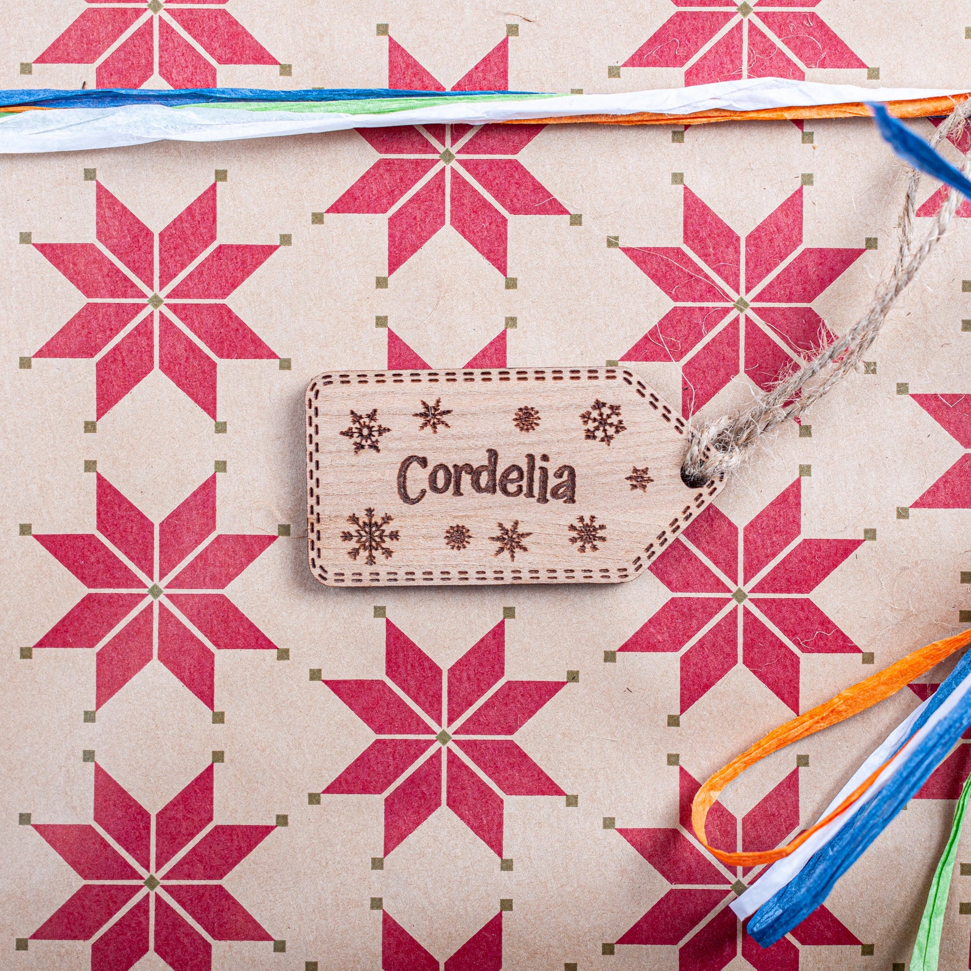 Laser cut wooden Christmas tag engraved with snowflake pattern and jute string