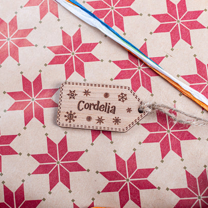 Rustic wooden gift tag with engraved snowflake detail for holiday presents