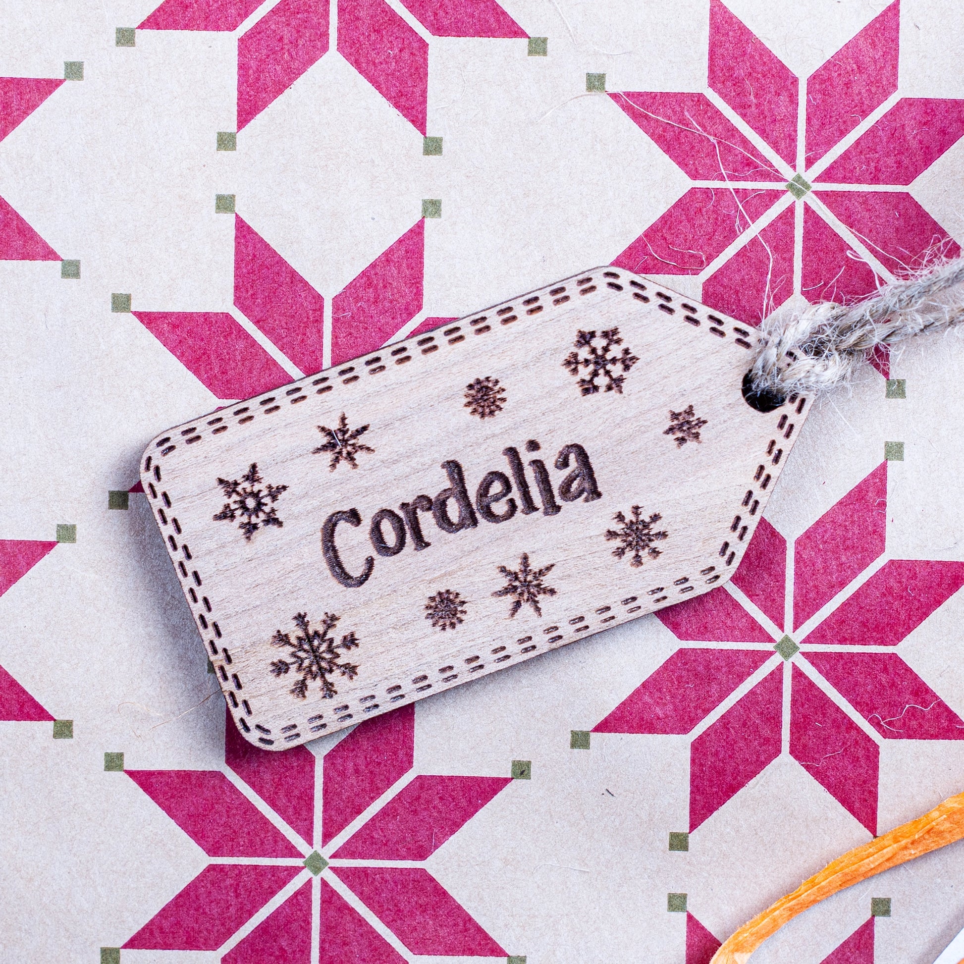 Engraved wooden Christmas gift tag with snowflake design and name engraving