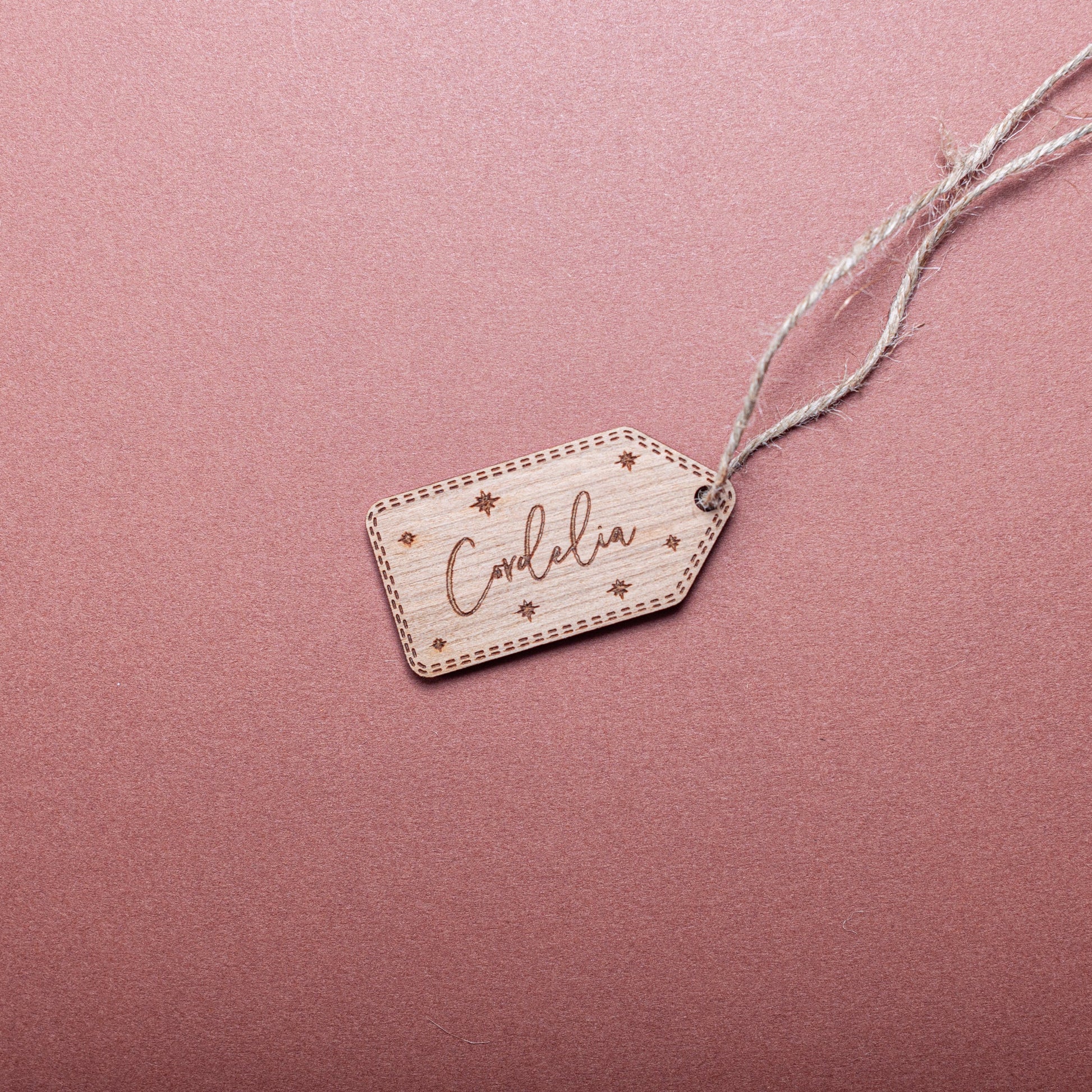 Engraved wooden gift tag with stars for Christmas wrapping décor