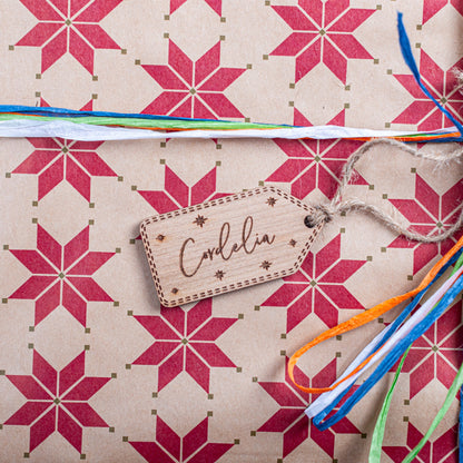 Laser cut wooden Christmas tag with engraved star design and ribbon
