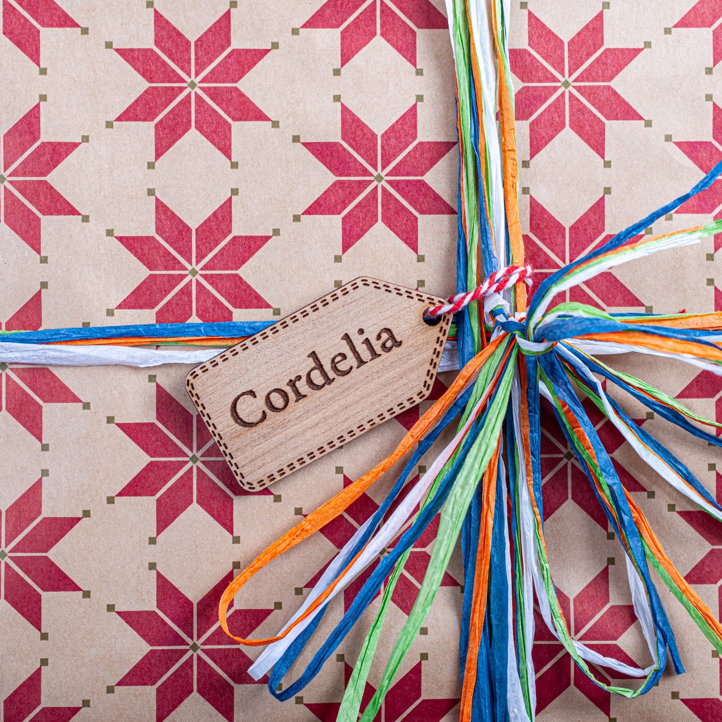 Personalised Christmas gift tag in natural wood with engraved festive design