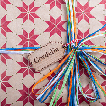 Personalised Christmas gift tag in natural wood with engraved festive design