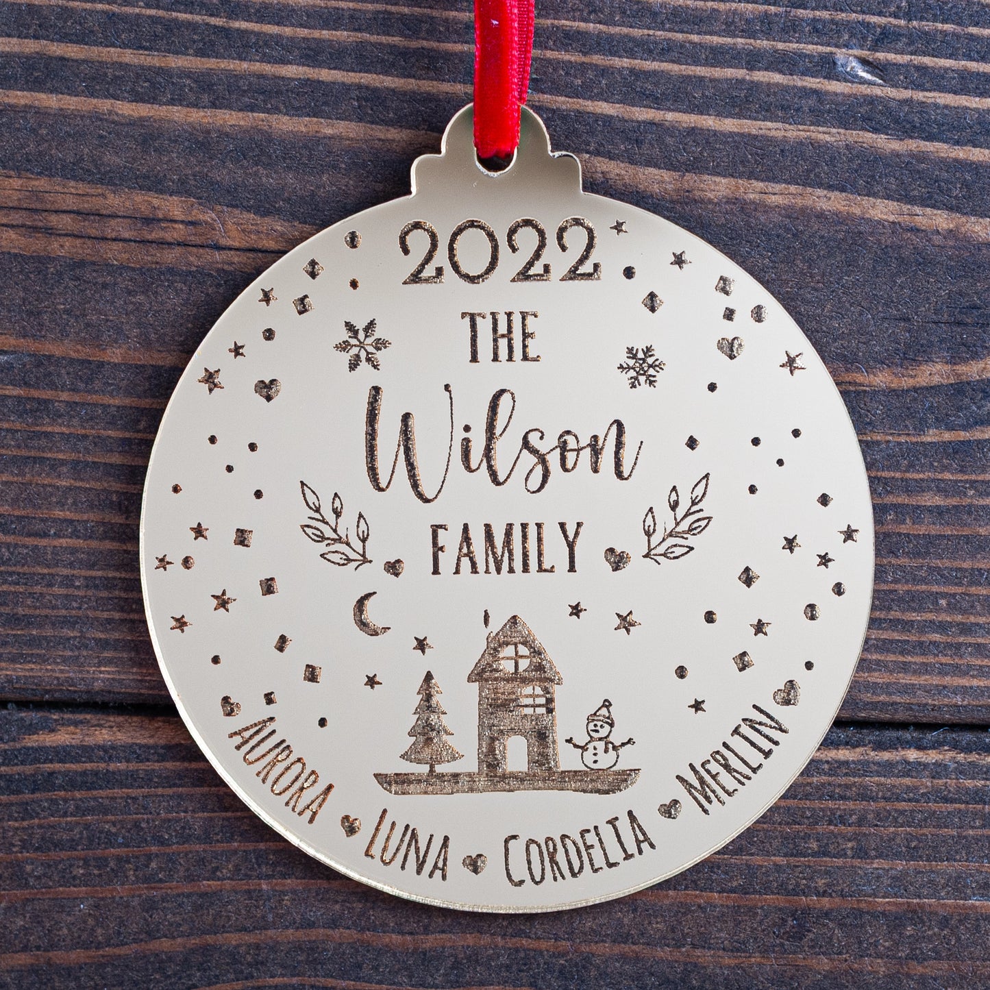 Engraved snowglobe-inspired family Christmas bauble in gold mirror