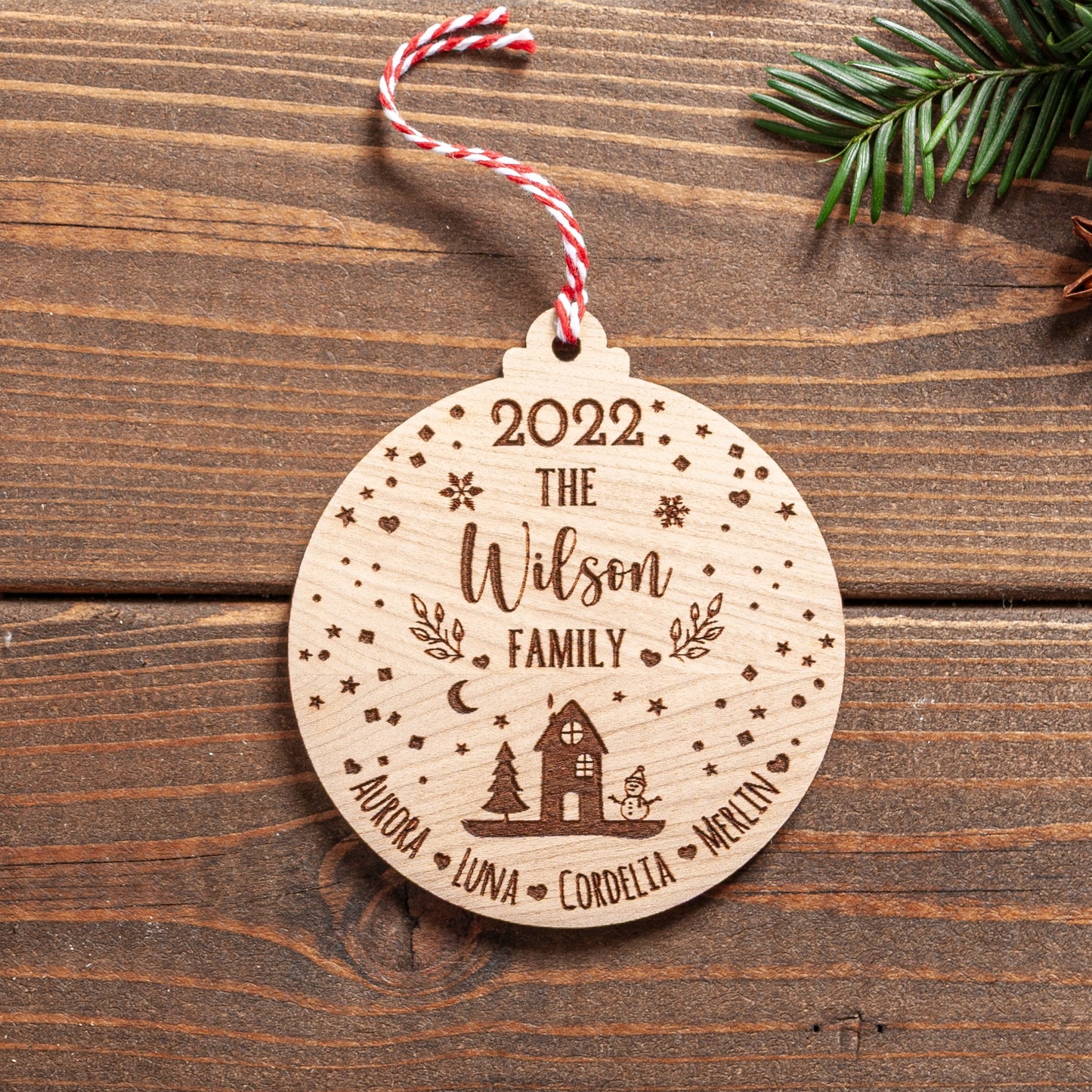 Personalised family Christmas bauble with engraved snowglobe design