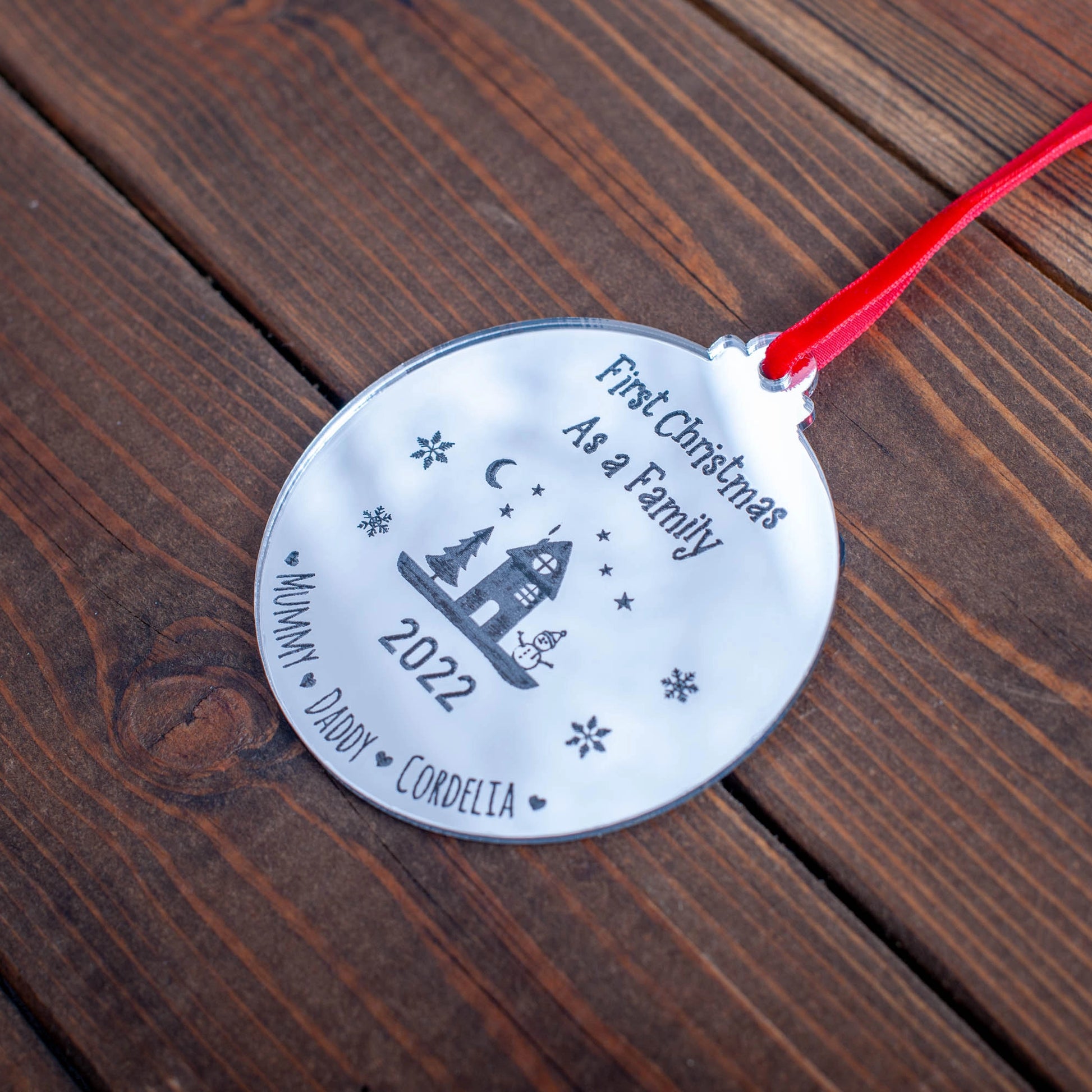 Personalised silver mirror bauble featuring family names and year