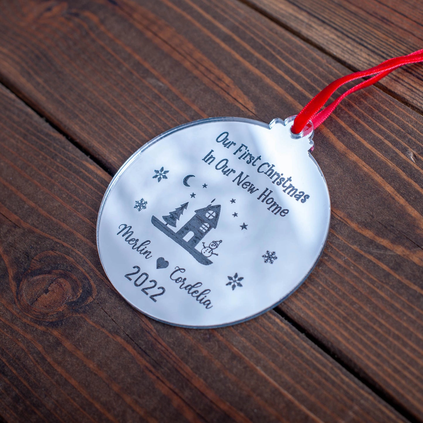 Reflective silver acrylic bauble engraved with names and new address