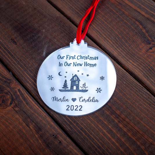 Silver mirror Christmas bauble engraved with “First Christmas in Our New Home” and year