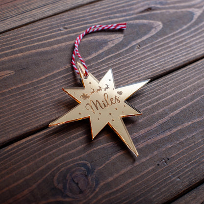 Personalised Polaris Christmas bauble engraved with name and star design