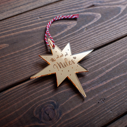 Personalised Polaris Christmas bauble engraved with name and star design