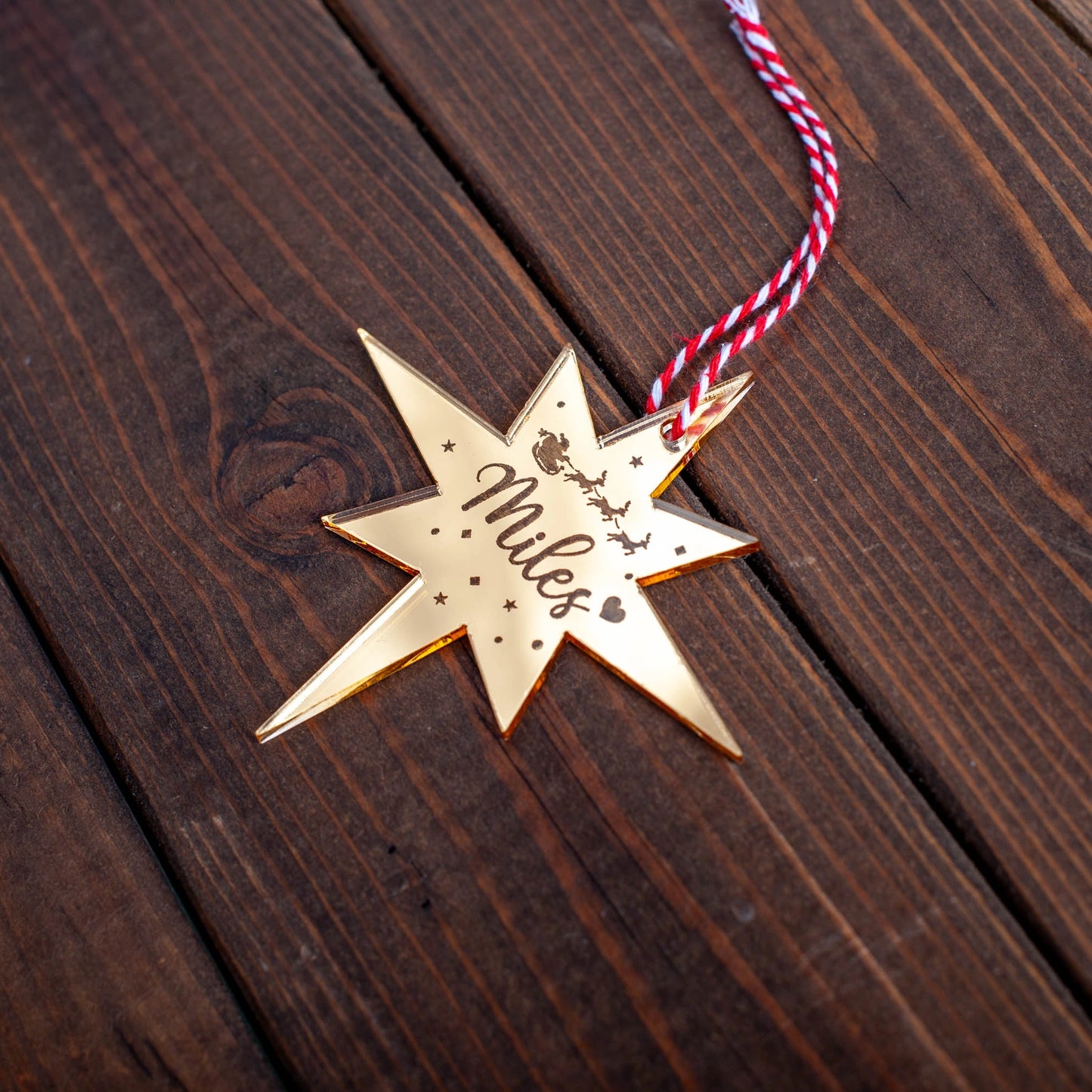 Personalised Christmas tree bauble featuring engraved Polaris star