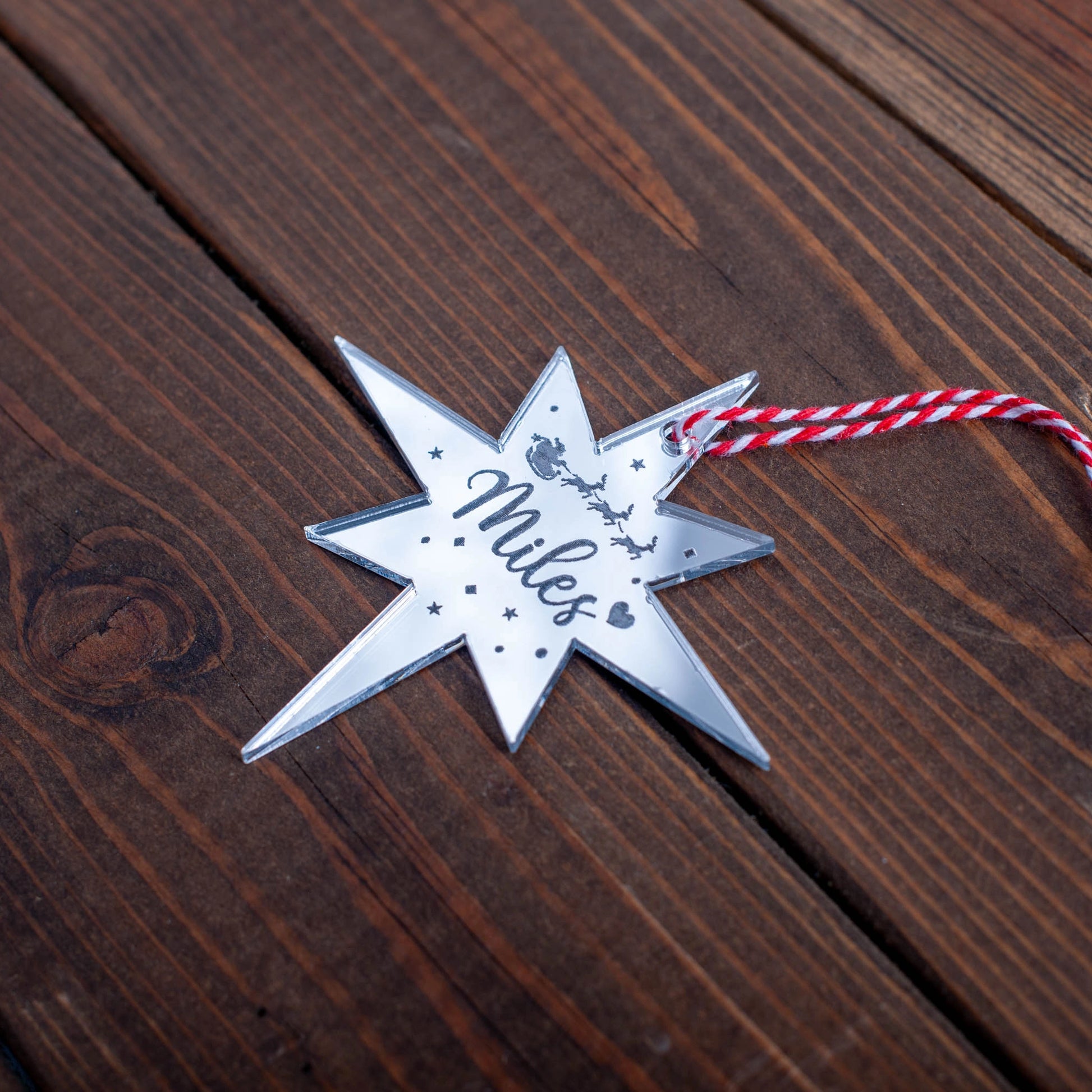 Silver mirror Christmas bauble engraved with name and celestial detail