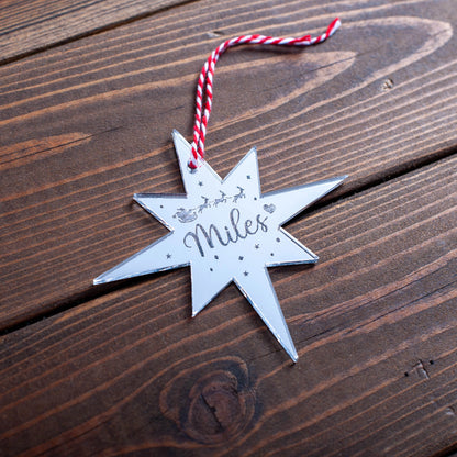 Silver mirror acrylic Polaris bauble ornament on Christmas tree