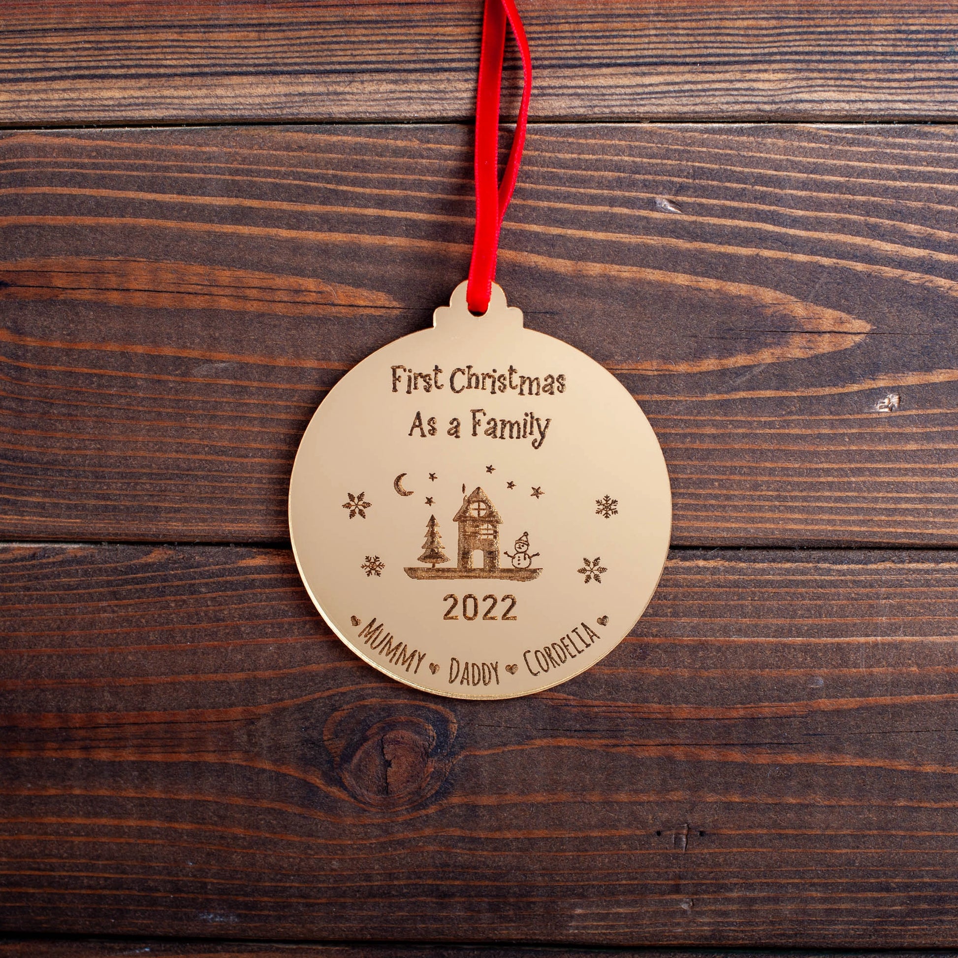 Engraved gold acrylic bauble for family’s first Christmas